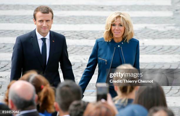 French President Emmanuel Macron and his wife Brigitte Trogneux attend the traditional Bastille day military parade on the Champs-Elysees on July 14,...