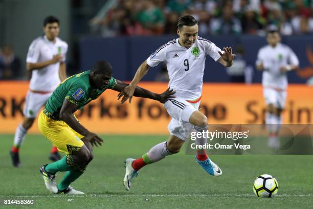 Erick Torres of Mexico fights for the ball with Oniel Fisher of Jamaica during a Group C match between Mexico and Jamaica as part of CONCACAF Gold...