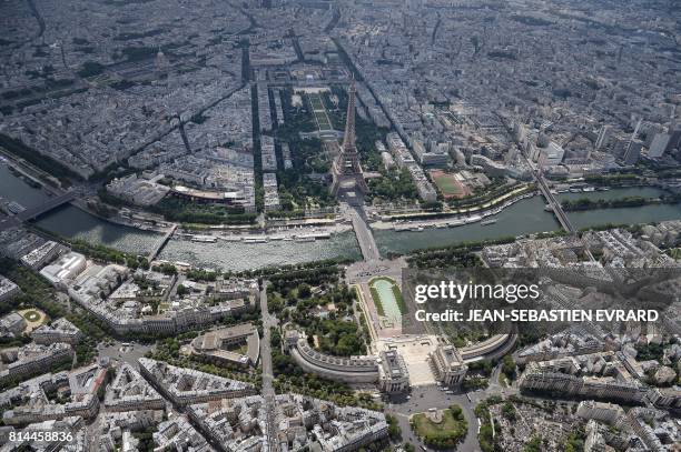 Picture taken on July 14 in Paris shows an aerial view of the Eiffel tower by the river Seine, in the middle between, on one side, the Champ de Mars...