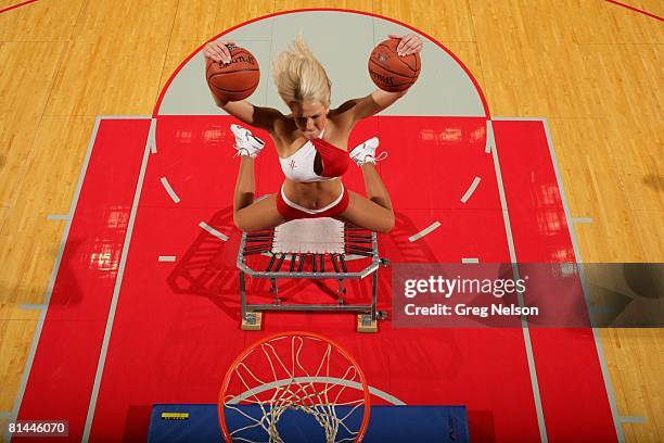 Basketball: Aerial view of Houston Rockets dance team cheerleader Carrie Barnhart making dunk from trampoline during game vs New York Knicks,...