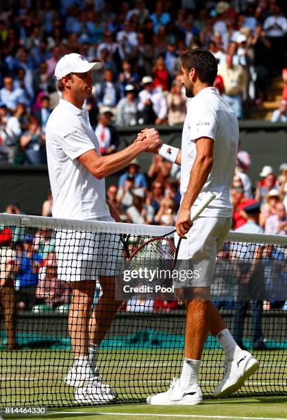 Marin Cilic of Croatia and Sam Querrey of The United States shake hands after the Gentlemen's Singles semi final match on day eleven of the Wimbledon...