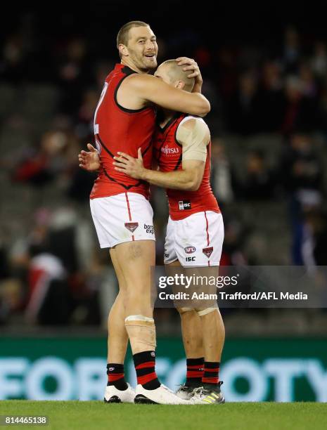 Tom Bellchambers of the Bombers celebrates with David Zaharakis of the Bombers on the final siren during the 2017 AFL round 17 match between the St...