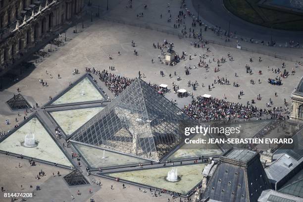 Picture taken on July 14 in Paris, shows an aerial view of the Louvre Pyramid located in the main courtyard, the Cour Napoleon, of the Louvre Palace...