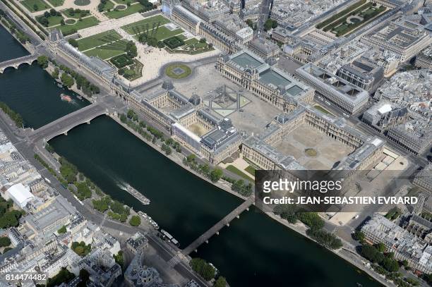 Picture taken on July 14 in Paris, shows an aerial view of the Louvre museum with its Louvre Pyramid located in the main courtyard, the Cour...