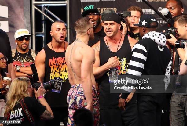 Conor McGregor speaks to members of Floyd Mayweather Jr.'s team during the Floyd Mayweather Jr. V Conor McGregor World Press Tour event at Barclays...