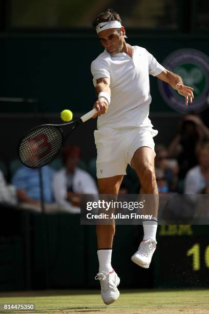 Roger Federer of Switzerland plays a forehand during the Gentlemen's Singles semi final match against Tomas Berdych of The Czech Republic on day...