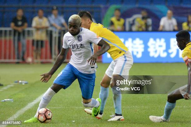 Mbaye Diagne of Tianjin Teda is challenged by Jiangsu Suning players during 2017 Chinese Super League 17th round match between Tianjin Teda and...