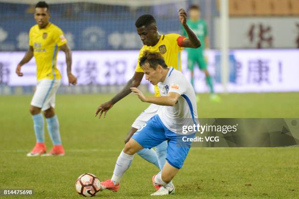 Hu Rentian of Tianjin Teda and Ramires of Jiangsu Suning compete for the ball during 2017 Chinese Super League 17th round match between Tianjin Teda...