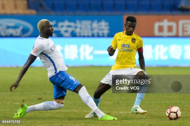 Mbaye Diagne of Tianjin Teda and Ramires of Jiangsu Suning compete for the ball during 2017 Chinese Super League 17th round match between Tianjin...