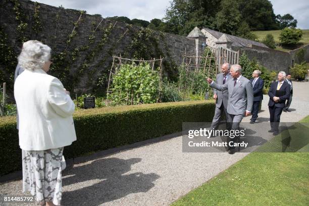 Prince Charles, Prince of Wales accompanied by Anthony Tavernor owner and restorer of the Plas Cadnant Hidden Gardens visits the gardens during The...