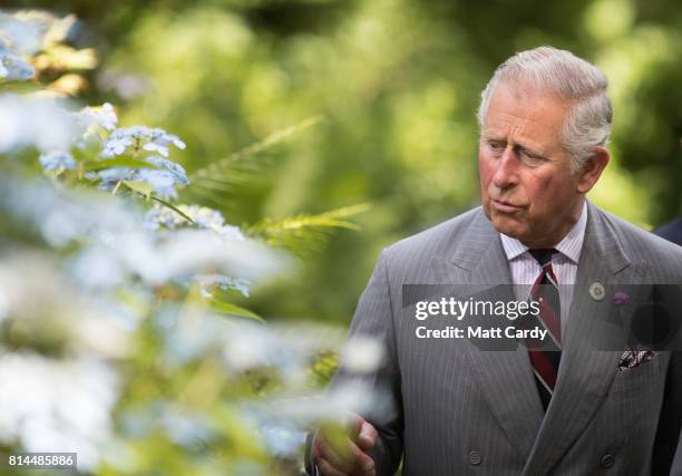 Prince Charles, Prince of Wales takes a tour of the gardens at Plas Cadnant Hidden Gardens during The Prince of Wales' annual summer visit to Wales...