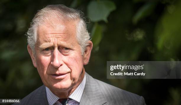 Prince Charles, Prince of Wales takes a tour of the gardens at Plas Cadnant Hidden Gardens during The Prince of Wales' annual summer visit to Wales...