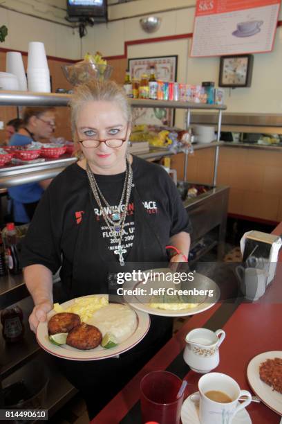 Waitress serving food at S & S Diner.