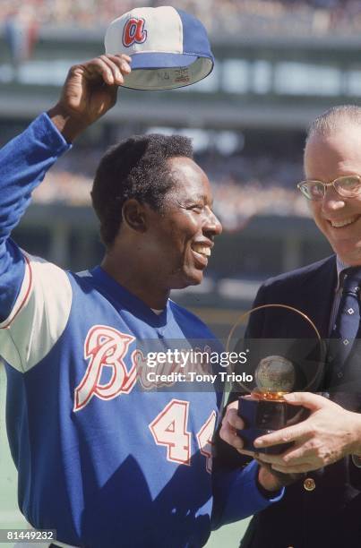 Baseball: Closeup of Atlanta Braves Hank Aaron with commissioner Bowie Kuhn victorious after hitting 714th career home run and tying Babe Ruth's...