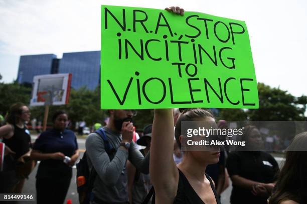 Gun-control activists participate in a rally outside the headquarters of National Rifle Association July 14, 2017 in Fairfax, Virginia. Women's March...
