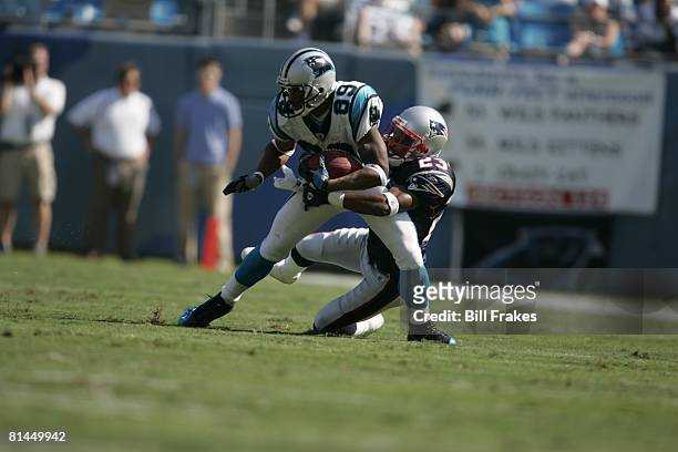 Football: Carolina Panthers Steve Smith in action during tackle vs New England Patriots Duane Starks , Charlotte, NC 9/18/2005