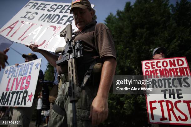 Armed gun rights activists counter-protest during a gun-control rally outside the headquarters of National Rifle Association July 14, 2017 in...