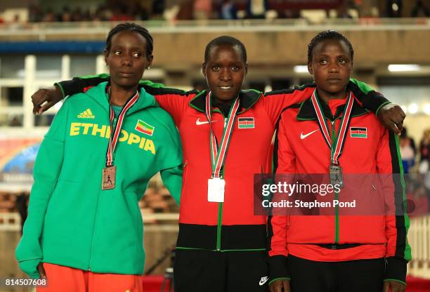 Bronze medalist Etalemahu Sintayehu of Ethiopia , gold medalist Caren Chebet of Kenya and silver medalist Mercy Chepkurui of Kenya pose with their...