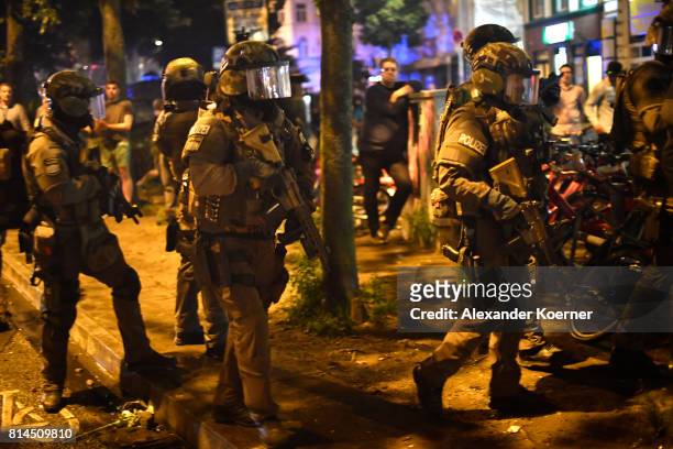 Police Members of a German SWAT from Bavaria hold a HK416 A5 machine gun towards an observed apartment complex, used by protesters from the left-wing...