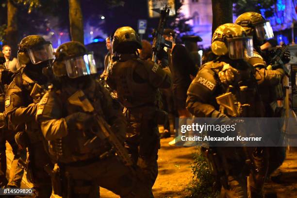 Police Members of a German SWAT from Bavaria hold a HK416 A5 machine gun towards an observed apartment complex, used by protesters from the left-wing...