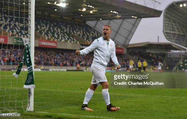 Leigh Griffiths of Celtic ties a Celtic scarf onto a goalpost which sparked crowd disorder after the Champions League second round first leg...