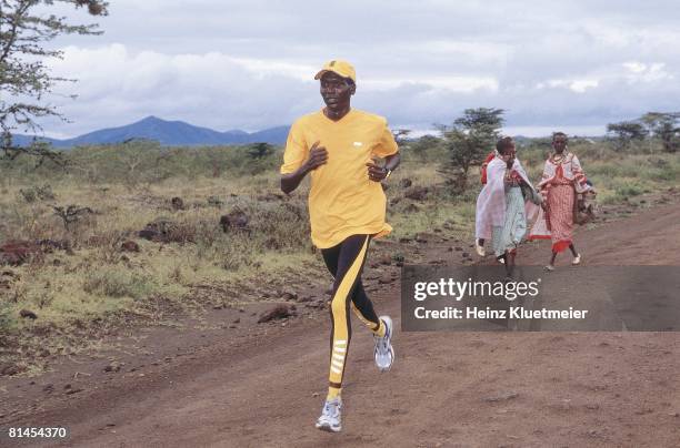 Track & Field: Scenic view of Kenyan marathon runner Paul Tergat in action on savannah with Ngong Hills in background, Macao Valley, KEN 3/27/2001