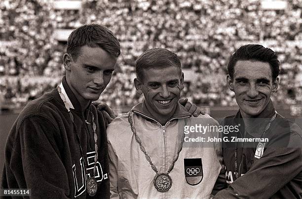 Track & Field: 1960 Summer Olympics, Closeup of USA David Sime, DEU Armin Hary, and GBR Peter Radford victorious with medals after 100M final race,...