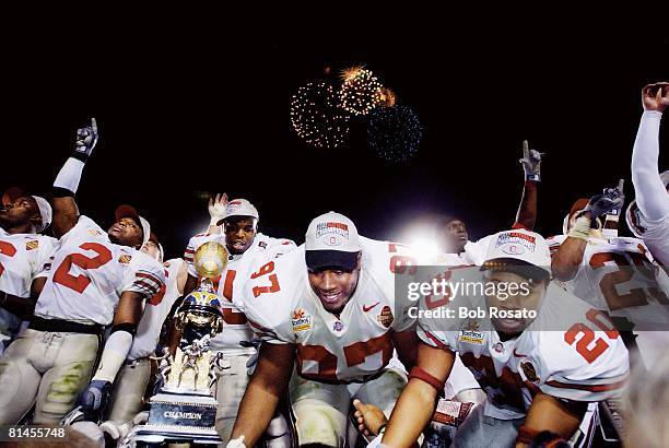 Coll, Football: Fiesta Bowl, Ohio State's Mike Doss , Kenny Peterson , and Chris Conwell victorious with trophy after winning game vs Miami, Tempe,...