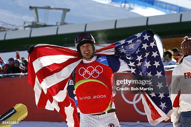 Snowboarding: 2006 Winter Olympics, Closeup of USA Seth Wescott victorious with flag after winning Snowboard Cross gold medal at Bardonecchia, Alta...