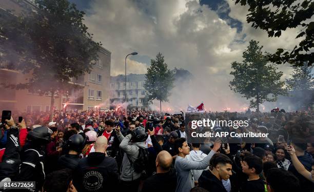 Fans gather outside of the home of Dutch midfielder Abdelhak Nouri on July 14, 2017 in Amsterdam. Ajax Amsterdam's football player Abdelhak Nouri was...