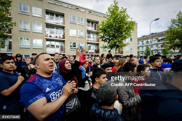 Fans gather outside of the home of Dutch midfielder Abdelhak Nouri on July 14, 2017 in Amsterdam. Ajax Amsterdam's football player Abdelhak Nouri was...