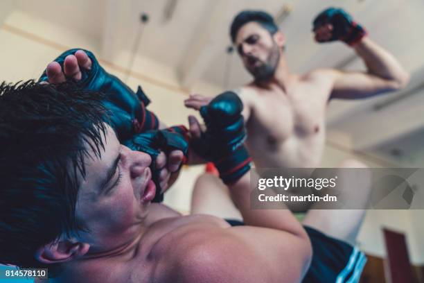 mma professional fighters boxing in the gym - jujitsu stock pictures, royalty-free photos & images