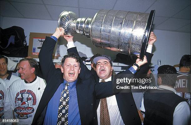 Hockey: Stanley Cup Finals, Colorado Avalanche coach Marc Crawford and general manager Pierre Lacroix victorious with trophy after game vs Florida...