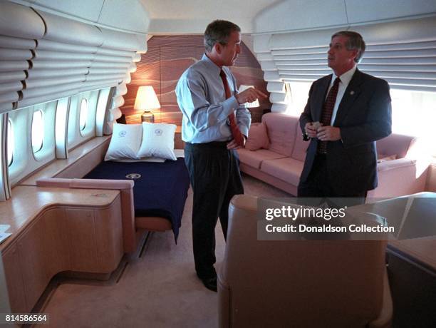 President George W. Bush confers with White House Chief of Staff Andy Card Tuesday, Sept. 11 in the President's stateroom aboard Air Force One. Photo...