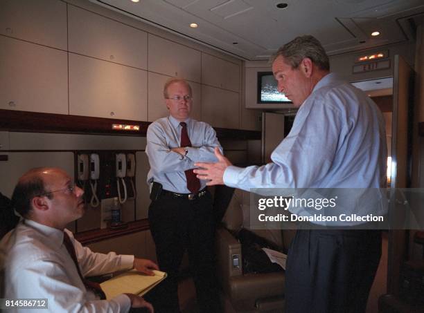 President George W. Bush speaks with Ari Fleischer, left, and Karl Rove aboard Air Force One Tuesday, Sept. 11 during the flight from Offutt Air...