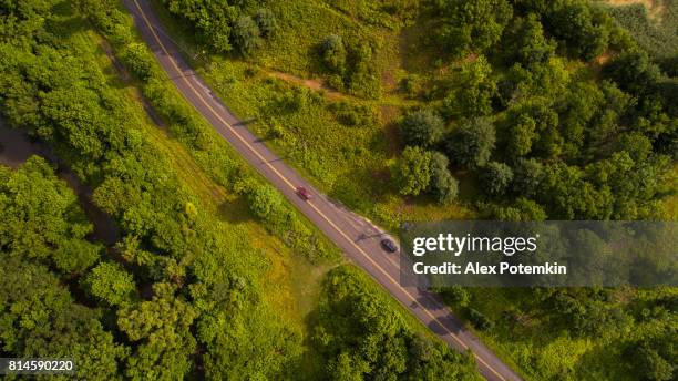 aerial drone view to the blue mountains covered by low clouds, poconos, pennsylvania, at the early morning. - pocono mountains region stock pictures, royalty-free photos & images