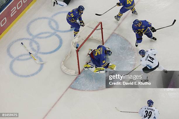 Hockey: 2006 Winter Olympics, Sweden goalie Henrik Lundqvist in action vs Finland Niklas Hagman during Gold Medal Game at Palasport Olimpico, Turin,...