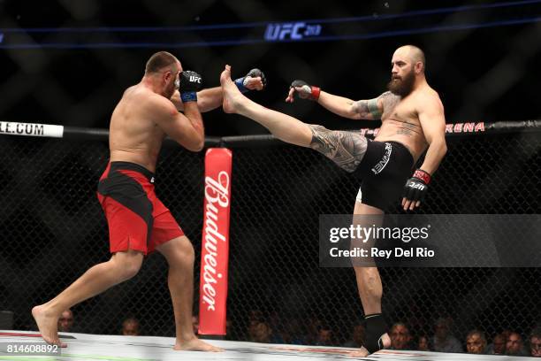 Travis Browne kicks Aleksei Oleinik in their heavyweight bout during the UFC 213 event at T-Mobile Arena on July 9, 2017 in Las Vegas, Nevada.