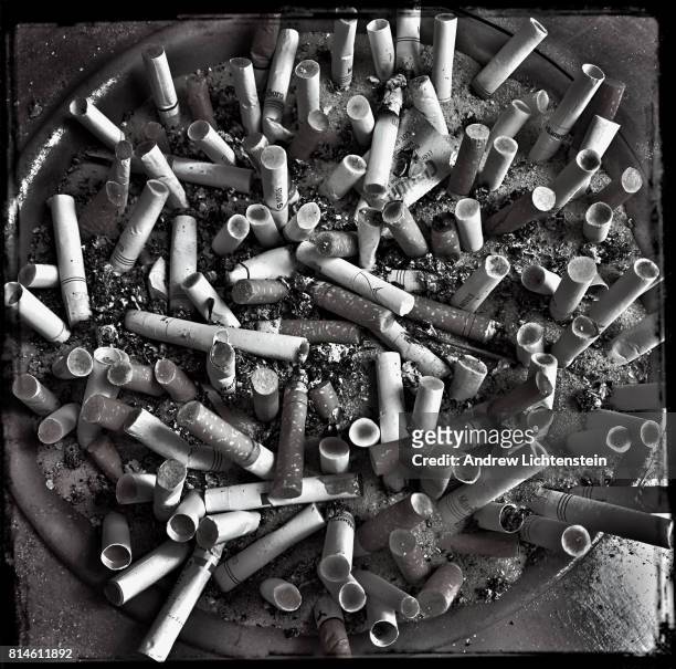 Discarded cigarettes fill an ashtray in a specially designated smoking area outside of a midtown Manhattan office building on April 17, 2017 in New...