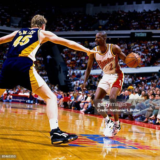 Stacy Augmon of the Atlanta Hawks moves the ball against Rick Smits of the Indiana Pacers in Game Two of the Eastern Conference Semifinals during the...