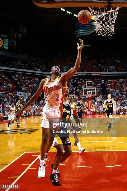 Stacy Augmon of the Atlanta Hawks shoots a layup against Derrick McKey of the Indinaa Pacers in Game Two of the Eastern Conference Semifinals during...