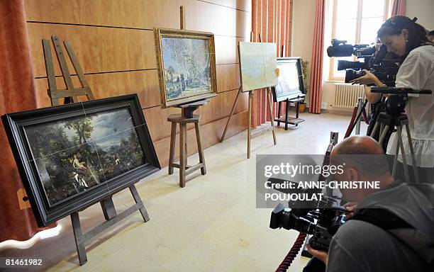 Journalists take pictures on June 05, 2008 in Marseille, southern France, of the four paintings, two Bruegels , a Sisley and a Monet which have been...
