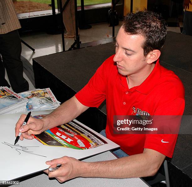 Driver Kyle Busch signs autographs for the employees of the Mars Candy Plant during Mars Employee Appreciation Day at Mars Headquarters on June 5,...