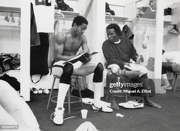 Cornerbacks Mike Haynes and Lester Hayes of the Los Angeles Raiders go over strategy in the locker room before a game against the Atlanta Falcons at...