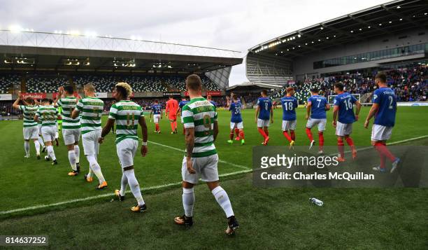 Linfield and Celtic make their way onto the pitch during the Champions League second round first leg qualifying game between Linfield and Celtic at...