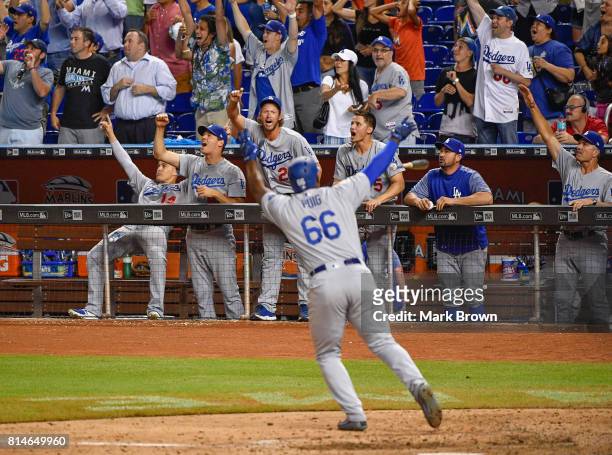 Yasiel Puig of the Los Angeles Dodgers hits a three run go ahead homer in the ninth inning during the game between the Miami Marlins and the Los...