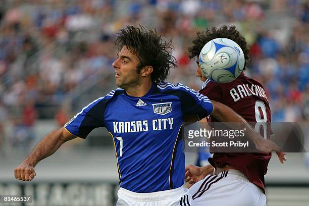 Claudio Lopez of the Kansas City Wizards challenges Mehdi Balloughy of the Colorado Rapids for the ball during the game at Shawnee Mission North High...