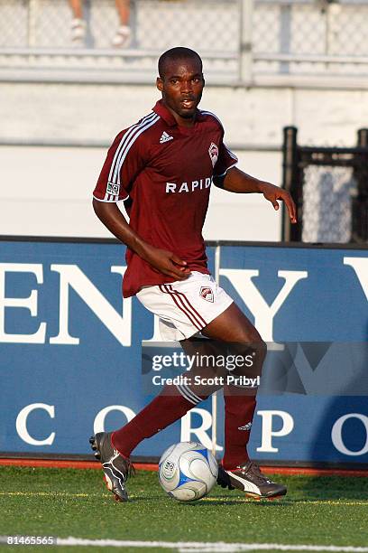 Omar Cummings of the Colorado Rapids dribbles against the Kansas City Wizards during the game at Shawnee Mission North High School on June 4, 2008 in...