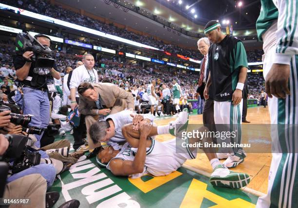 Paul Pierce of the Boston Celtics holds his knee in pain against the Los Angeles Lakers during Game One of the NBA Finals at TD Banknorth Garden on...