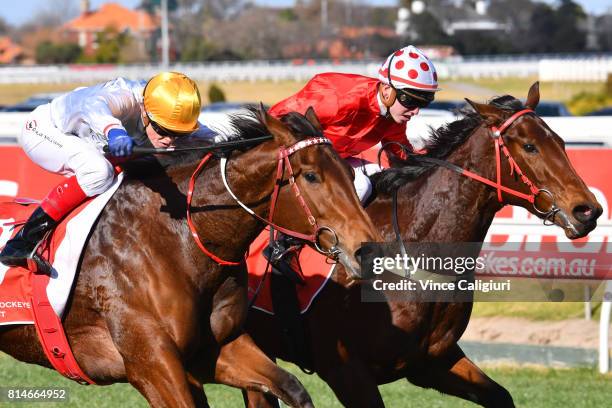 Craig Williams riding Moonlites Choice defeats Brandon Stockdale riding Hot Dipped in Race 3, during Melbourne Racing at Caulfield Racecourse on July...